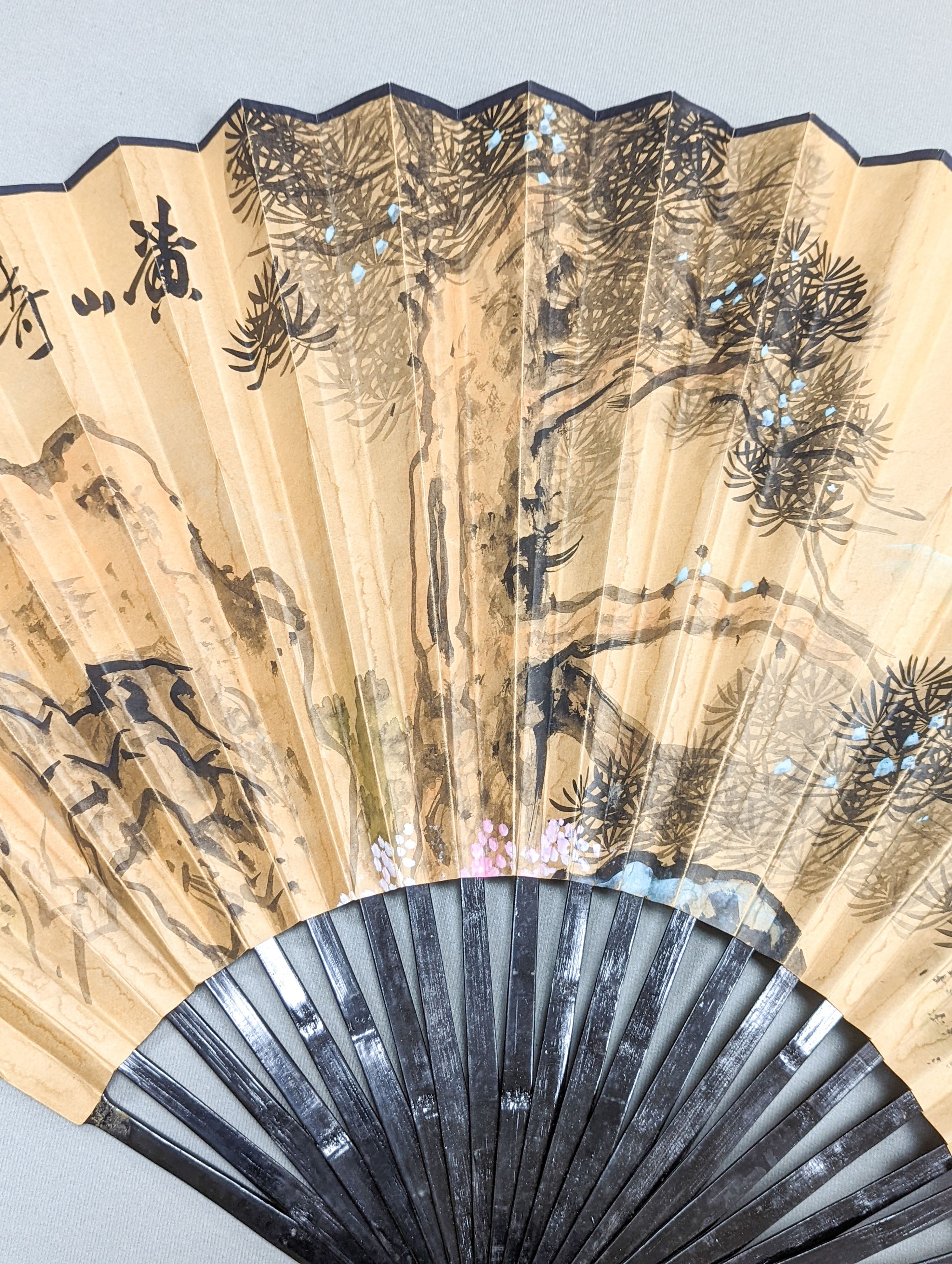 A large Chinese fan, the leaf painted with a landscape, signed Radius 60cm